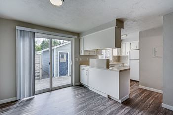 an empty kitchen with a sliding glass door to a patio